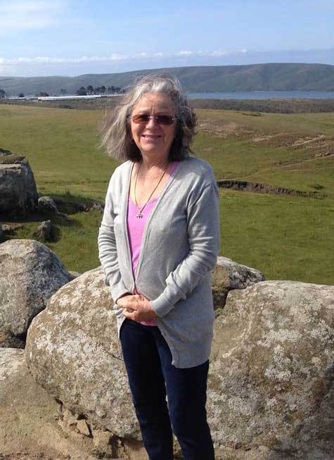 Pauli Halstead standing in front of green field