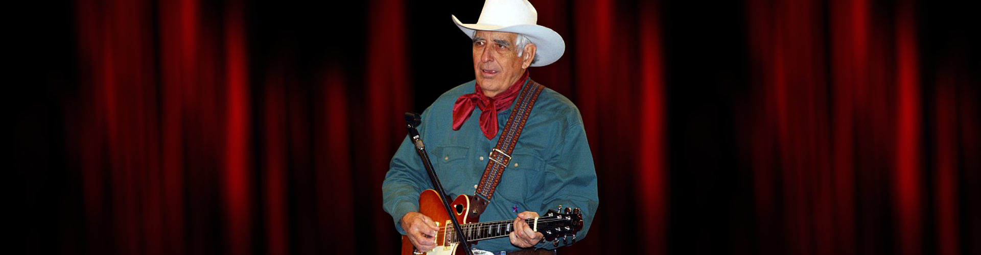 Tommy allsup with guitar on stage