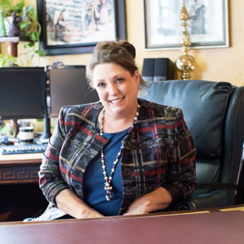 Julie Ketterman sitting at desk in her office